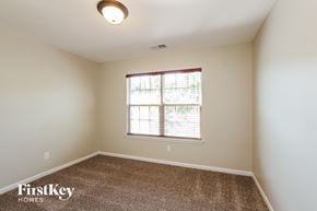 Charlotte house for rent - a spacious room with carpet and a window