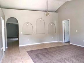 Jacksonville house for rent - an empty living room with three arches on the wall