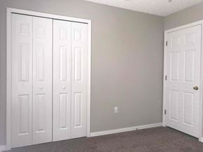 Jacksonville house for rent - an empty bedroom with two white doors and a carpeted floor