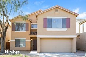 Litchfield Park house for rent - a beige house with a garage and a tree