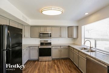 Litchfield Park house for rent - a kitchen with stainless steel appliances and white cabinets