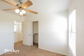Litchfield Park house for rent - a bedroom with a ceiling fan and a closet