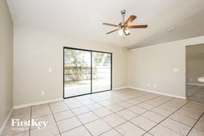 Apopka house for rent - an empty living room with a ceiling fan and a sliding glass door