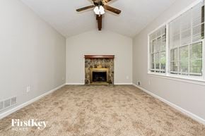 Conyers house for rent - A room with a fireplace and a ceiling fan.