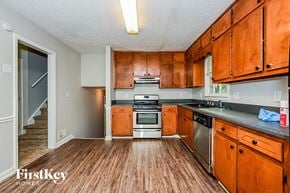 Conyers house for rent - A kitchen with wooden cabinets and a stainless steel dishwasher.
