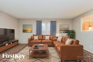 Indianapolis house for rent - A living room with a brown leather couch and a wooden coffee table.