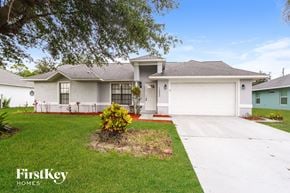 Palm Bay house for rent - a white house with a lawn and a driveway