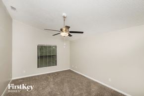 Palm Bay house for rent - a bedroom with a ceiling fan and a window