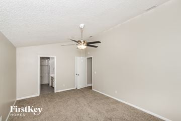 Palm Bay house for rent - a living room with carpet and a ceiling fan