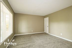 Hazelwood house for rent - A room with a carpet floor and a door.
