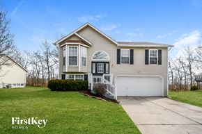 Black Jack house for rent - A house with a garage and a driveway in front of it.