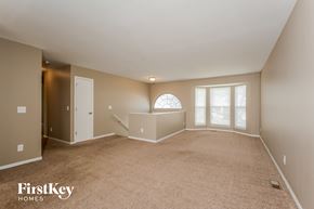 Black Jack house for rent - A spacious room with a carpeted floor and a large window.