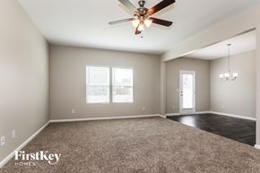 Midland house for rent - A spacious room with a ceiling fan and carpeted floor.