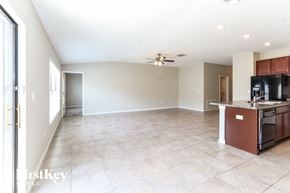 Riverview house for rent - A spacious kitchen and living room with a tile floor and a ceiling fan.