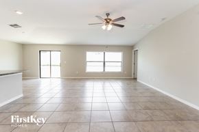 Riverview house for rent - A spacious room with a ceiling fan and tile flooring.