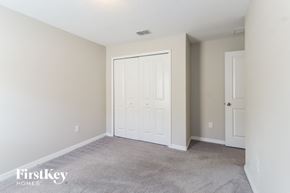 Riverview house for rent - A bedroom with a white door and carpeted floor.