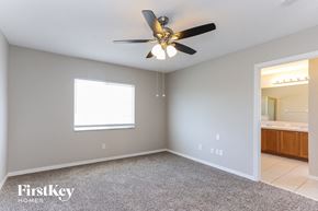 Riverview house for rent - the master bedroom has a ceiling fan and a carpet