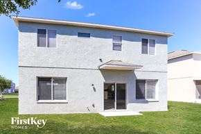 Riverview house for rent - the front of a white house with a door and grass
