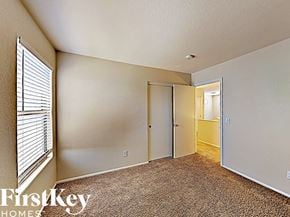 Litchfield Park house for rent - a bedroom with a large window and a door to a hallway