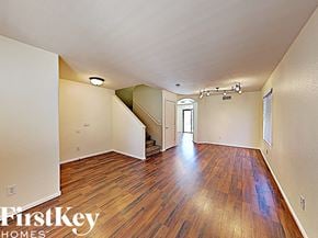 Litchfield Park house for rent - a spacious living room with hardwood flooring and a door to a staircase