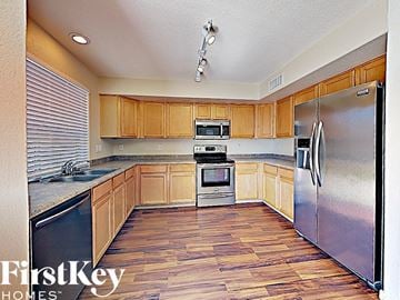Litchfield Park house for rent - a kitchen with wooden floors and stainless steel appliances