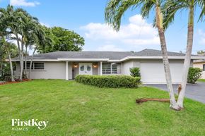 Plantation house for rent - A house with a palm tree in front of it.