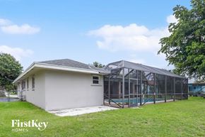 Plantation house for rent - A house with a pool and a glass enclosed area.