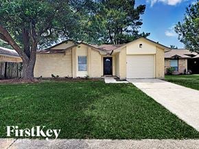 Houston house for rent - a small yellow house with a yard and a tree