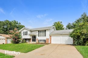 Florissant house for rent - A house with a driveway and a garage is for sale.