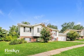 Florissant house for rent - A house with a lawn and a tree in front of it.