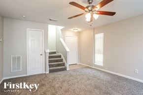 Houston house for rent - a living room with a ceiling fan and stairs