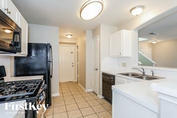 Houston house for rent - a kitchen with a stove and a sink and a refrigerator