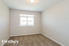 Houston house for rent - a spacious room with carpet and a window