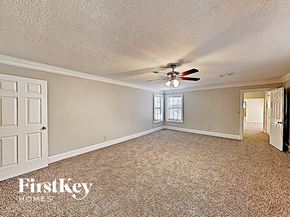 Cypress house for rent - the living room of a house with a ceiling fan