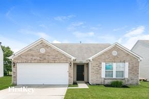Indianapolis house for rent - a brick house with a white garage door