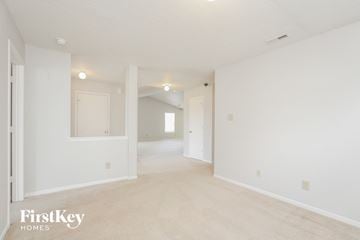 Indianapolis house for rent - the living room and dining room of an apartment with white walls and carpet