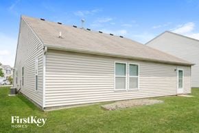 Indianapolis house for rent - the front of a white house with a grassy yard