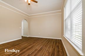 Gibsonton house for rent - the living room of an empty house with wood floors and a large window