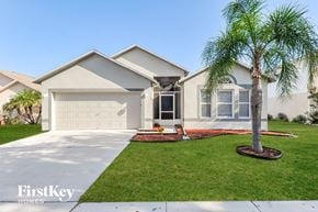 Gibsonton house for rent - a home with a palm tree in front of it