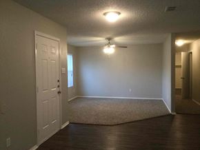 Cedar Hill house for rent - an empty living room with a white door and a ceiling fan