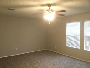 Cedar Hill house for rent - a bedroom with a ceiling fan and two windows