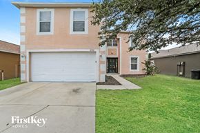 Gibsonton house for rent - a white garage door in front of a brick house