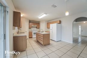 Gibsonton house for rent - a large kitchen with white appliances and wooden cabinets