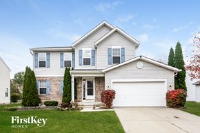 Fishers house for rent - a white house with blue shutters and a white garage door