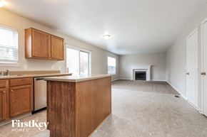 Fishers house for rent - an empty kitchen and living room with a fireplace