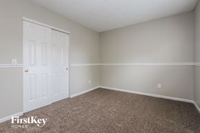 Fishers house for rent - a bedroom with a carpeted floor and a white door