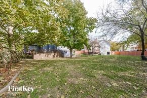 Olathe house for rent - A backyard with a lawn and trees.