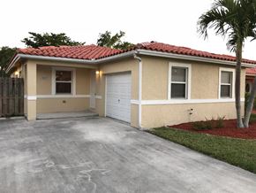 Homestead house for rent - a home with a driveway and a garage door