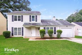 Stone Mountain house for rent - A white house with a black roof and a small front yard.
