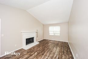 Stone Mountain house for rent - A room with a fireplace and wooden floors.